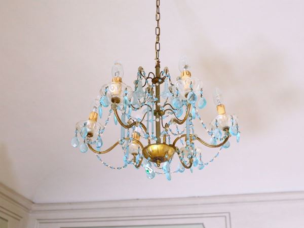 A gilted metal and blue glass small chandelier