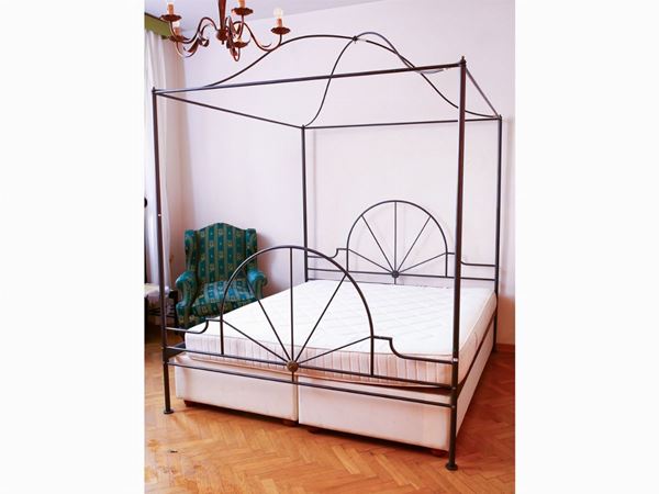 An ebonized metal canopy bed