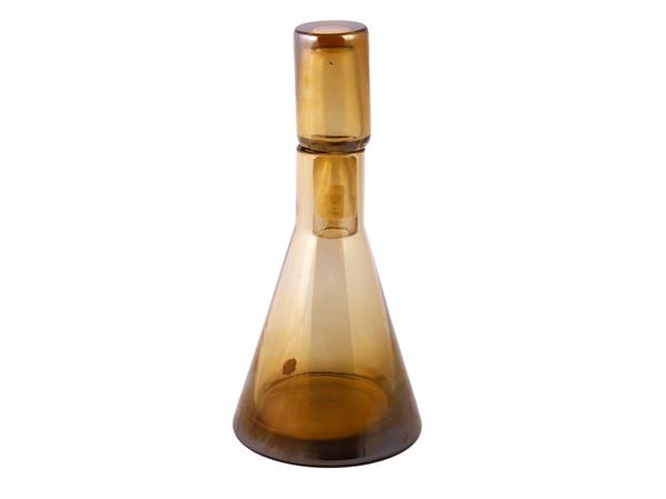 A yellow gold glass bottle with iridised surface
