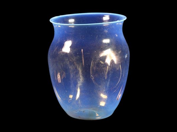 A thin small opalescent blue glass vase