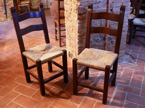 Twelve rustic walnut chairs