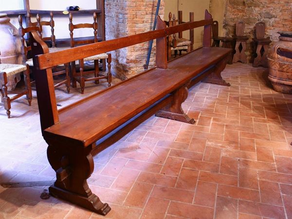 A large rustic softwood bench