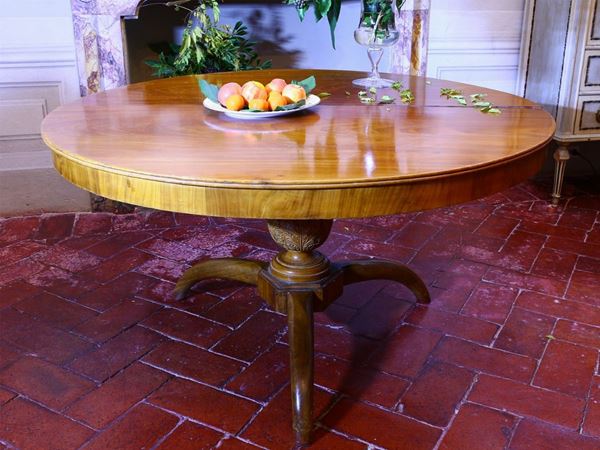 A round walnut veneered dining table