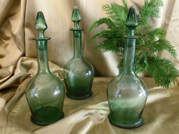 Five green blown glass wine bottles