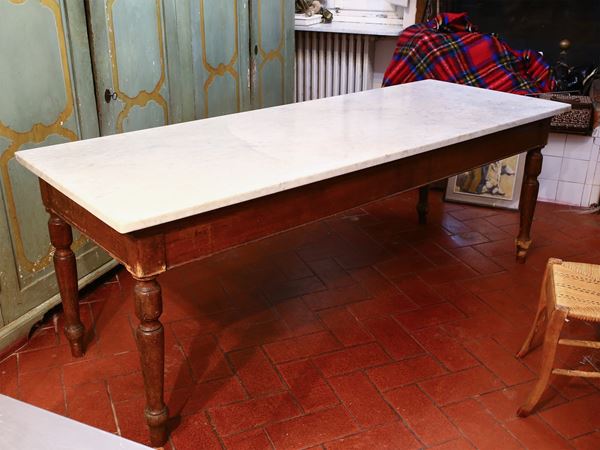 A kitchen softwood table with a marble top