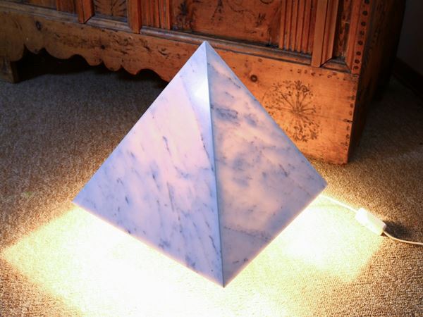 A white marble pyramid shaped table lamp