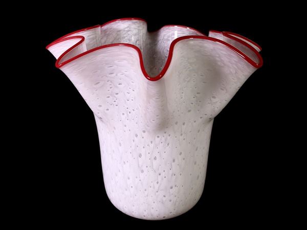A blown milk glass vase with an applied red glass ribbon
