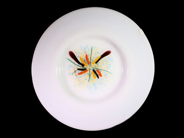 A big milk glass plate with an abstract polychrome decor