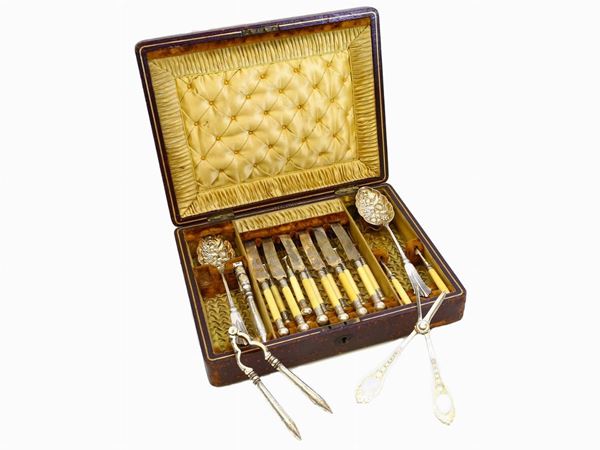 A metal silver and ivory cutlery set