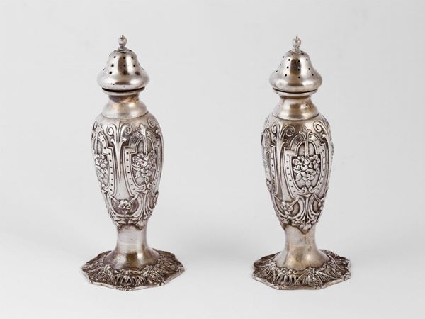 A pair of sterling silver salt shakers