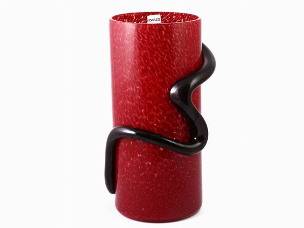 A coral glass vase with an applied black band