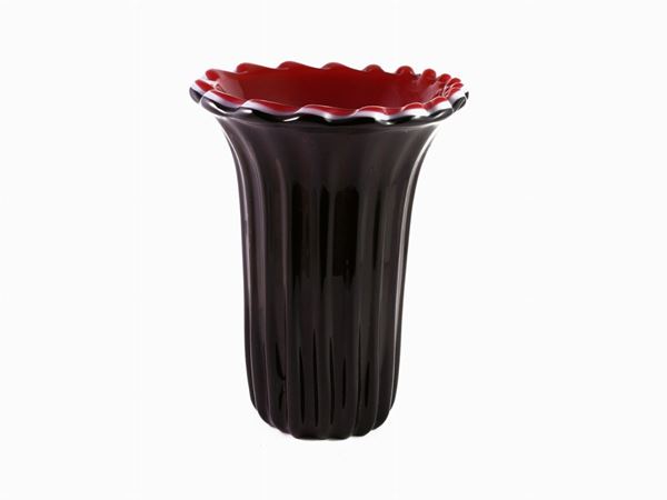 A vase in black and pink cased glass
