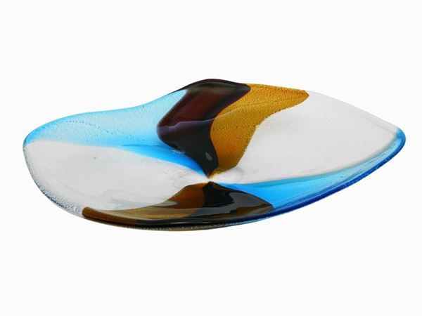 An irregularly shaped glass plate with multicoloured wedgs decoration and silver leaf inclusion