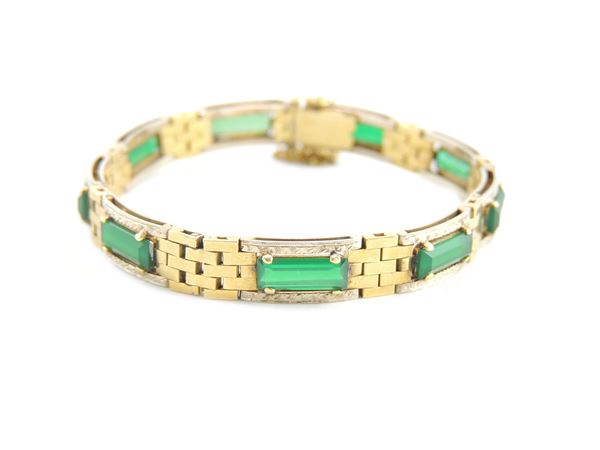 Yellow gold bracelet with green glasses