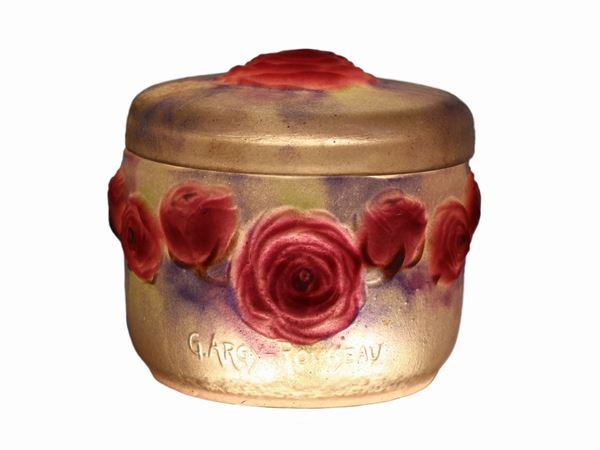 A circular Gabriel Argy-Rosseau pate-de-verre box with red rosee in relief