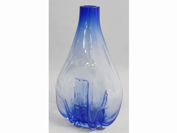 A mould-blown blue glass vase