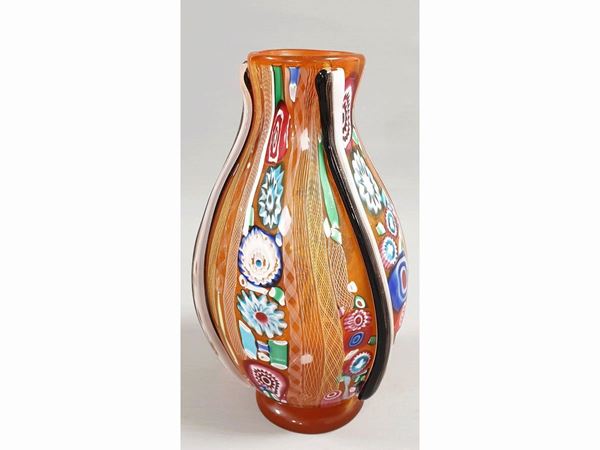 A glass orange vase with multycolour murrine.