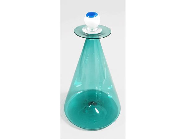 A trasparent green inverted cone bottle with lattimo and blue stopper. Signed De Majo Murano