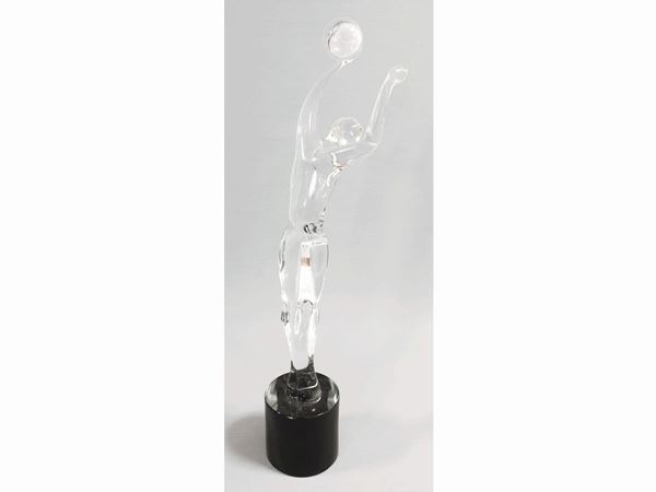 A crystal volleyball player with black base. Signed Renato Anatra