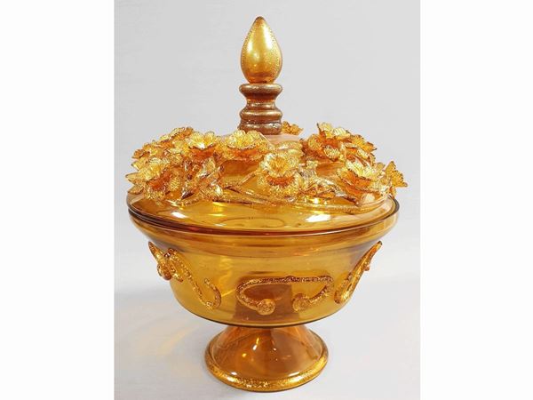 A lidded chalice in amber glass with floral decoration