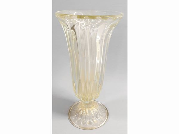 A big costolato glass vase with golden leaf.