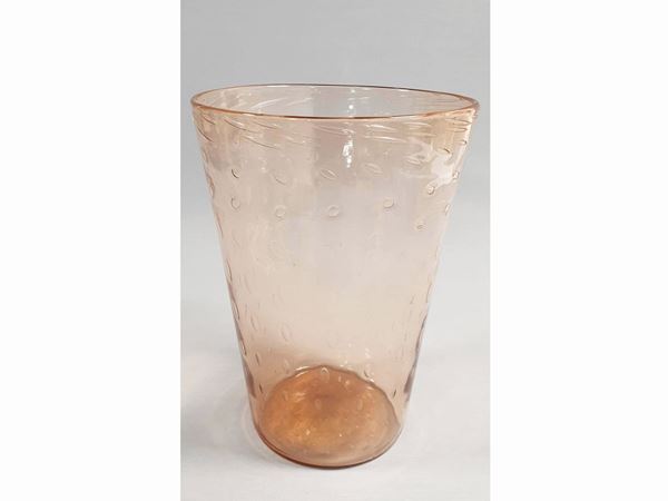 An orange trasparent glass vase with regular bubbles. Signed Venini Murano.