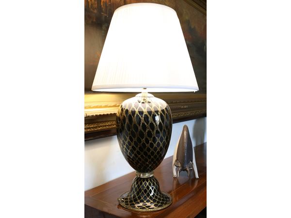 A black glass table lamp with balloton golden leaf