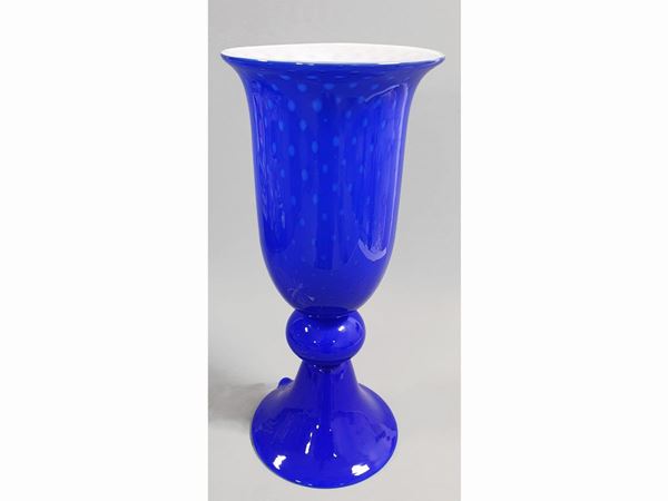 A lattimo and blue cased vase with regoular bubbles