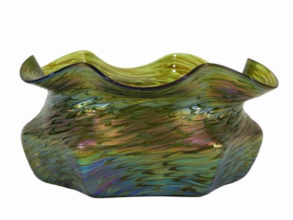 A Loetz bowl iridescent green glass with wavy edge