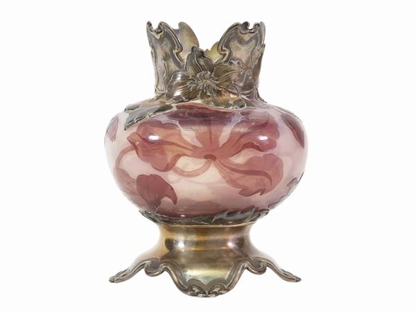 A Daum vase with cameo iris decoration on an opalescent background with silver base and neck.
