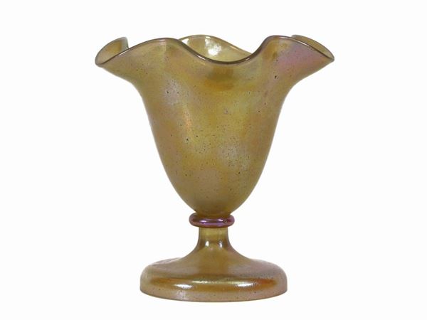 A small vase with wide wavy mouth in iridescent yellow glass