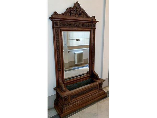 A walnut neo-renaissance mirror with planter
