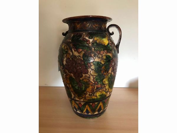 A small glazed terracotta jar