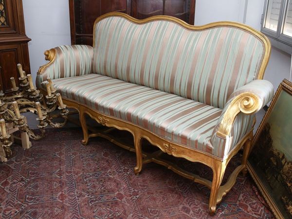 A large giltwood sofa