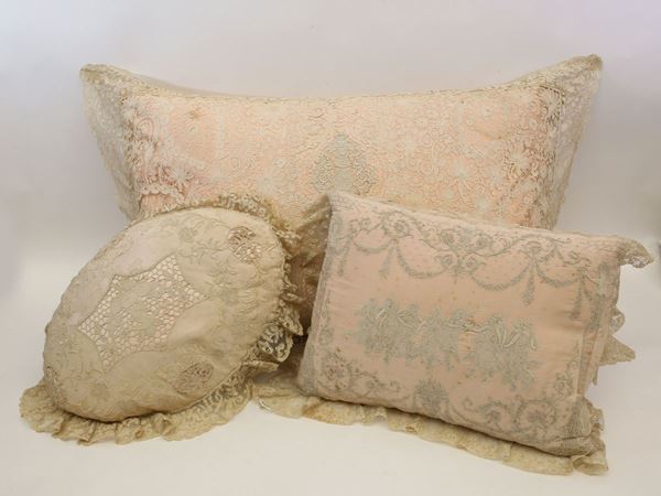 Three embroidered pillows