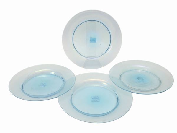 Quattro antichi piatti in vetro soffiato celeste