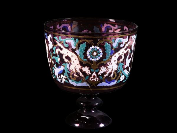 Amethist-coloured glass cup decorated with polychrome enamels.