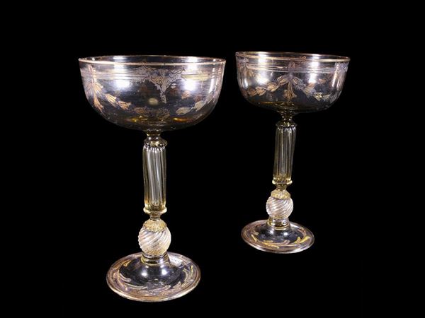 Two straw-coloured blown glass glasses with festoons painted in pure gold.