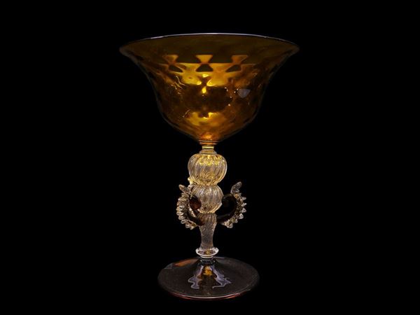 Ocher yellow blown glass bowl with colourless glass stem and heat applied curls.