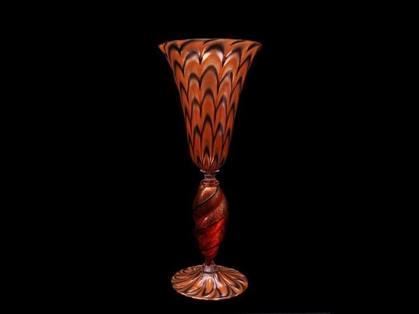 A blown glass in fancy orange colour with inclusions o aventurine and applications of glass threads