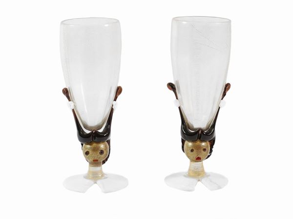 Pair of glasses with stem depicting faces in milky glass. One of which is damaged with restauration.