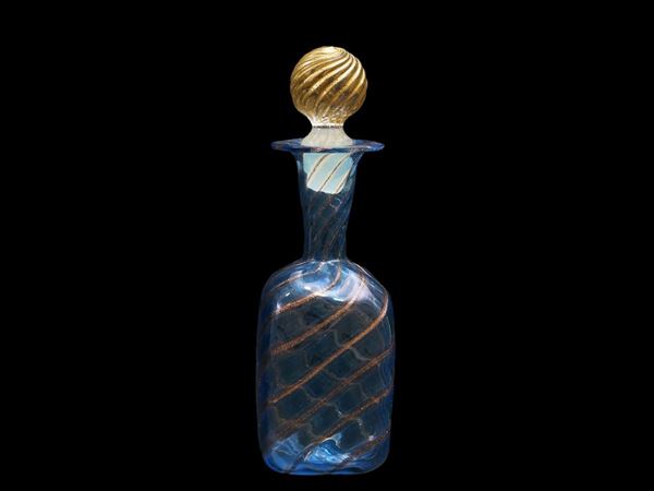 Small bottle in blown glass with blue and lattimo filigree.