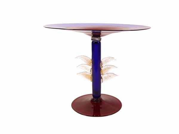 A riser in cobalt blue and ruby red blown glass with applications of leaves with golden inclusions.