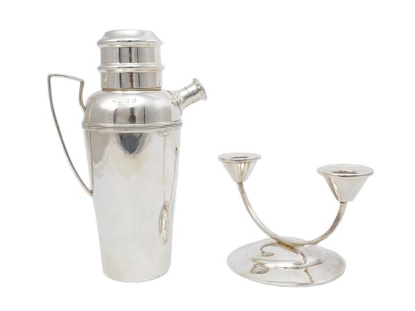 A silver shaker and candlestick