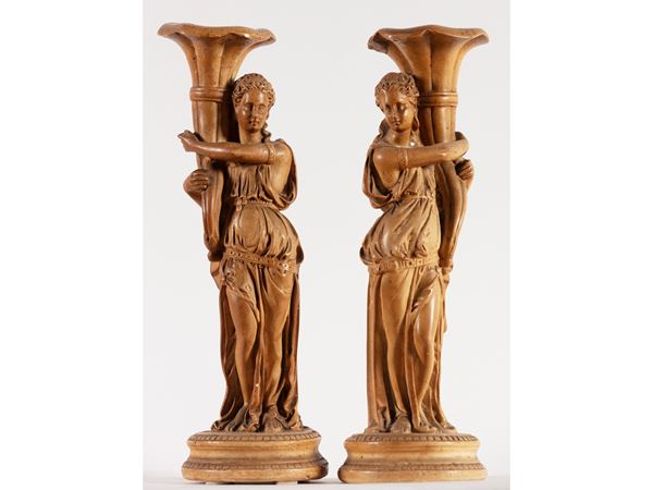 A pair of terracotta candlesticks