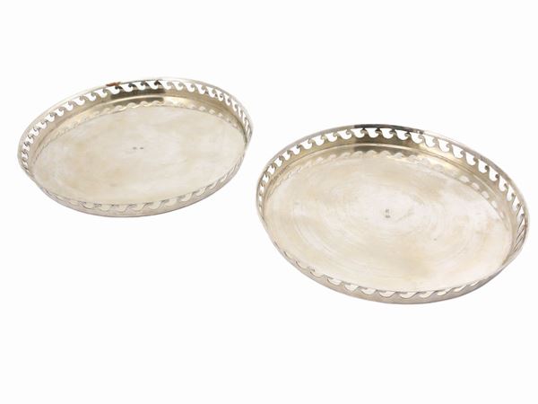 A pair of small circular silver trays