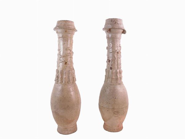 A couple of enamelled terracotta vases