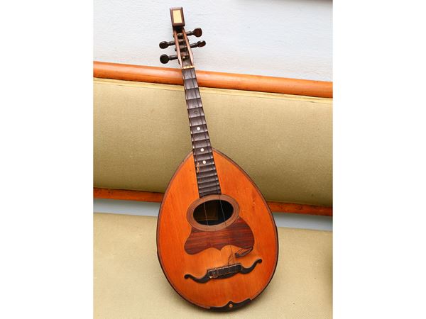 A cherrywood veneered mandolin  (Florence, Pilade Maurri 1920)  - Auction Furniture and Paintings from the Ancient Fattoria Franceschini, partly from Villa I Pitti - Maison Bibelot - Casa d'Aste Firenze - Milano