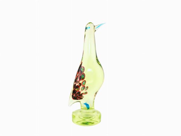 Thick green glass figure with murrine inclusions on the mantle
