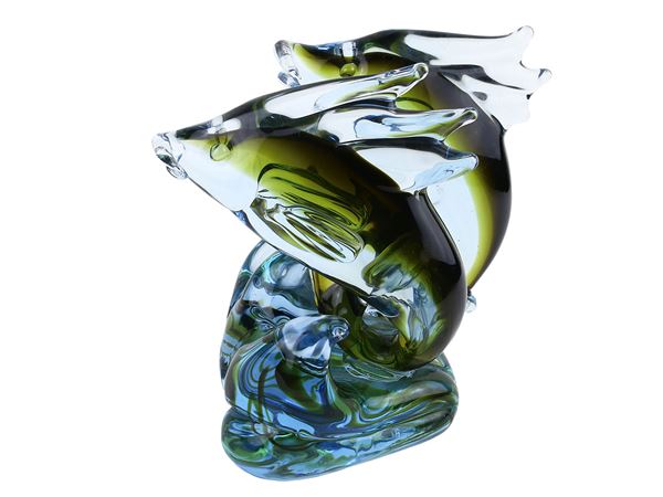 Group of two dolphins on a wave in blue submerged glass